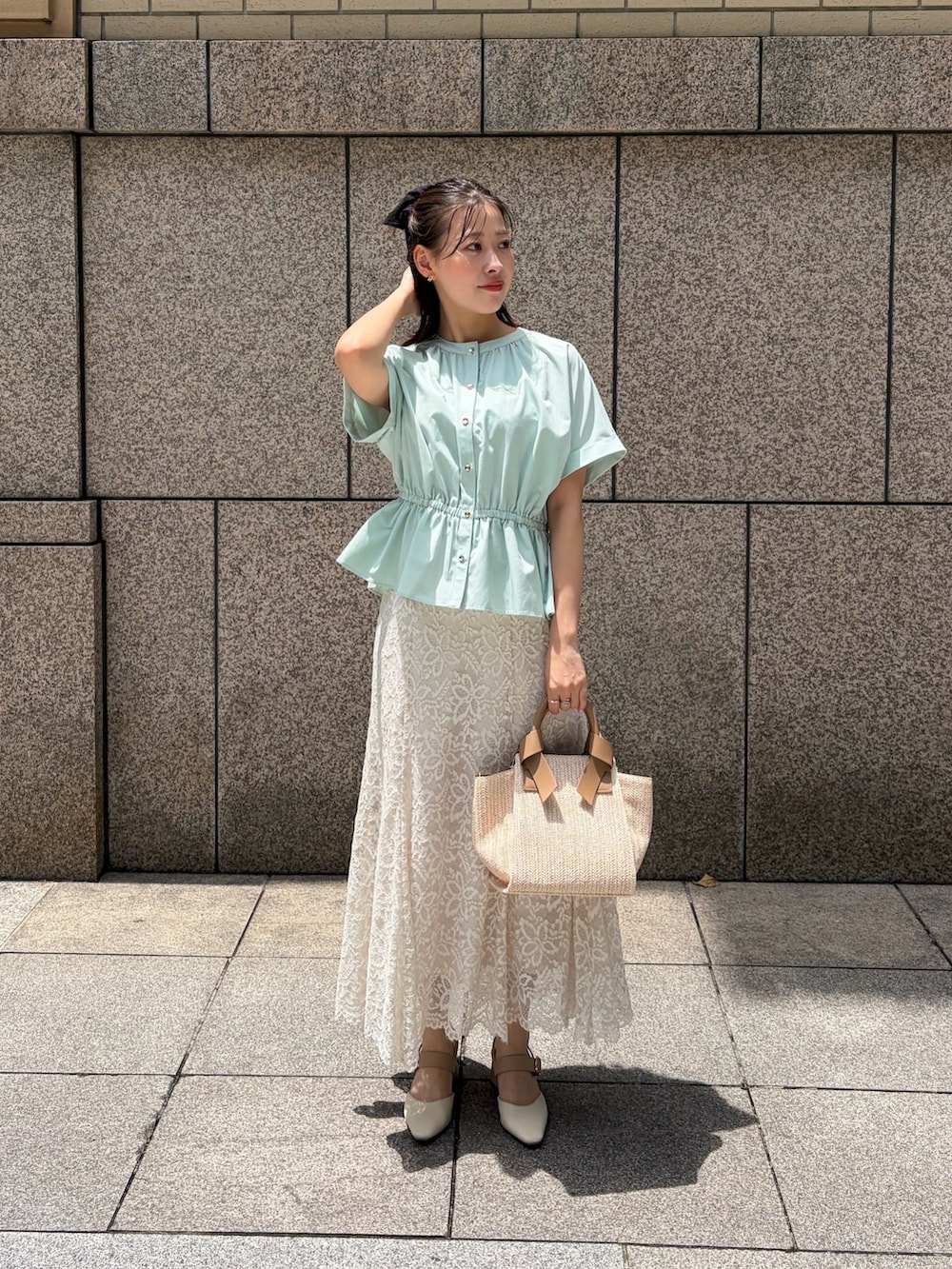 グリーン系のシャツ/ブラウス、ホワイト系のスカート、ホワイト系のトートバッグを着用したレディースの夏コーディネートの2枚目の写真