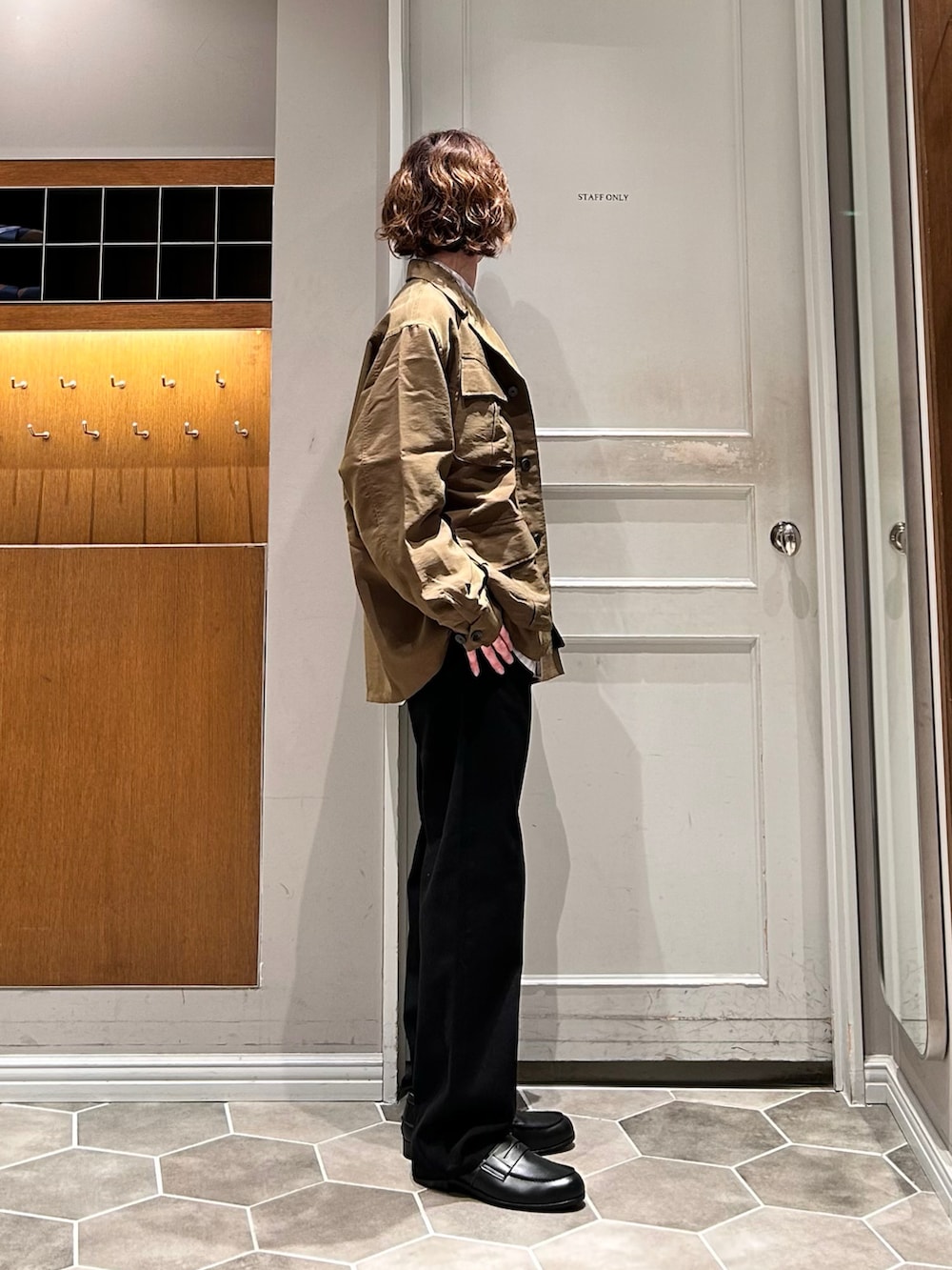 グリーン系のブルゾン、ベージュ系のシャツ/ブラウス、ブラック系のデニムパンツを着用したメンズの春コーディネートの2枚目の写真