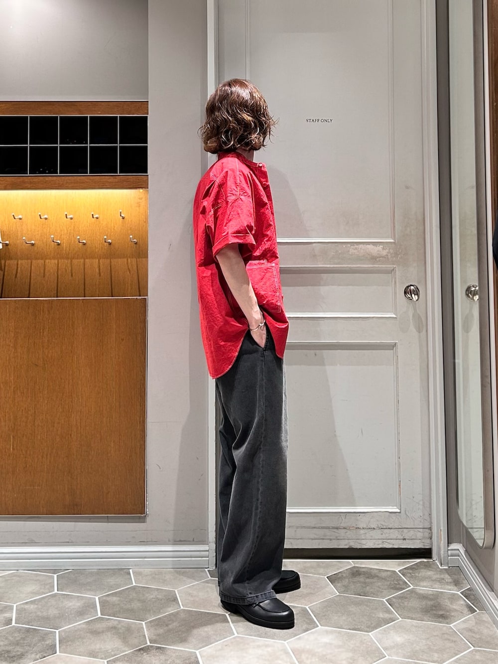 ブラック系のデニムパンツ、ブラック系のローファー、レッド系のシャツ/ブラウスを着用したメンズの夏コーディネートの2枚目の写真