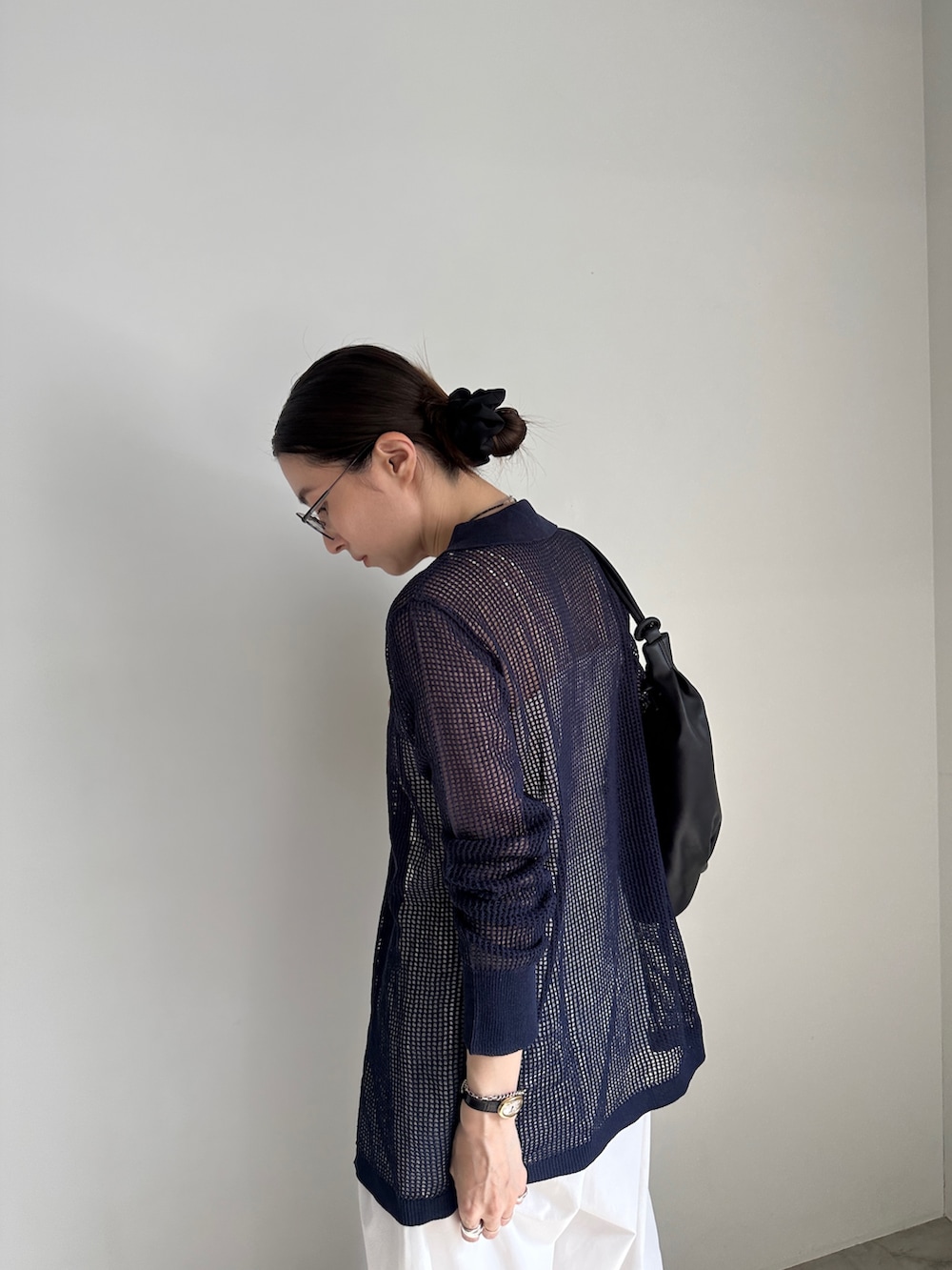 ホワイト系のその他パンツ、ブルー系のカーディガン/ボレロ、ブラック系のショルダーバッグを着用したレディースの春コーディネートの5枚目の写真