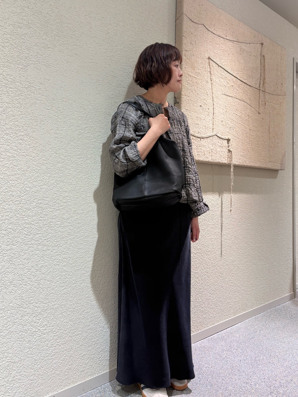 ブラック系のシャツ/ブラウス、ブラック系のトートバッグ、ブラック系のスカートを着用したレディースの春コーディネートの2枚目の写真