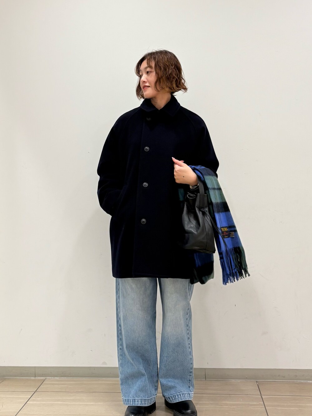 ブルー系のピーコート、その他のカーディガン/ボレロ、ブルー系のデニムパンツを着用したレディースの秋コーディネートの4枚目の写真