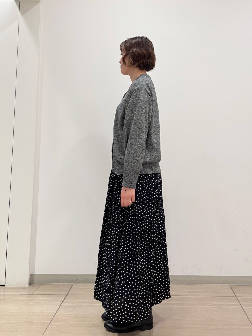 グレー系のニット/セーター、ブラック系のスカートを着用したレディースの冬コーディネートの4枚目の写真