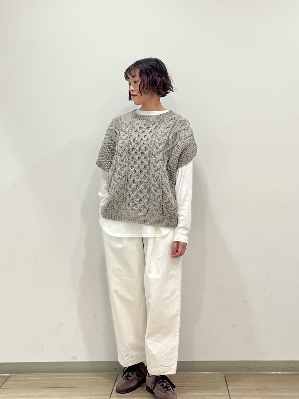 グリーン系のニット/セーター、ホワイト系のTシャツ/カットソー、ホワイト系のその他パンツを着用したレディースの秋コーディネートの2枚目の写真