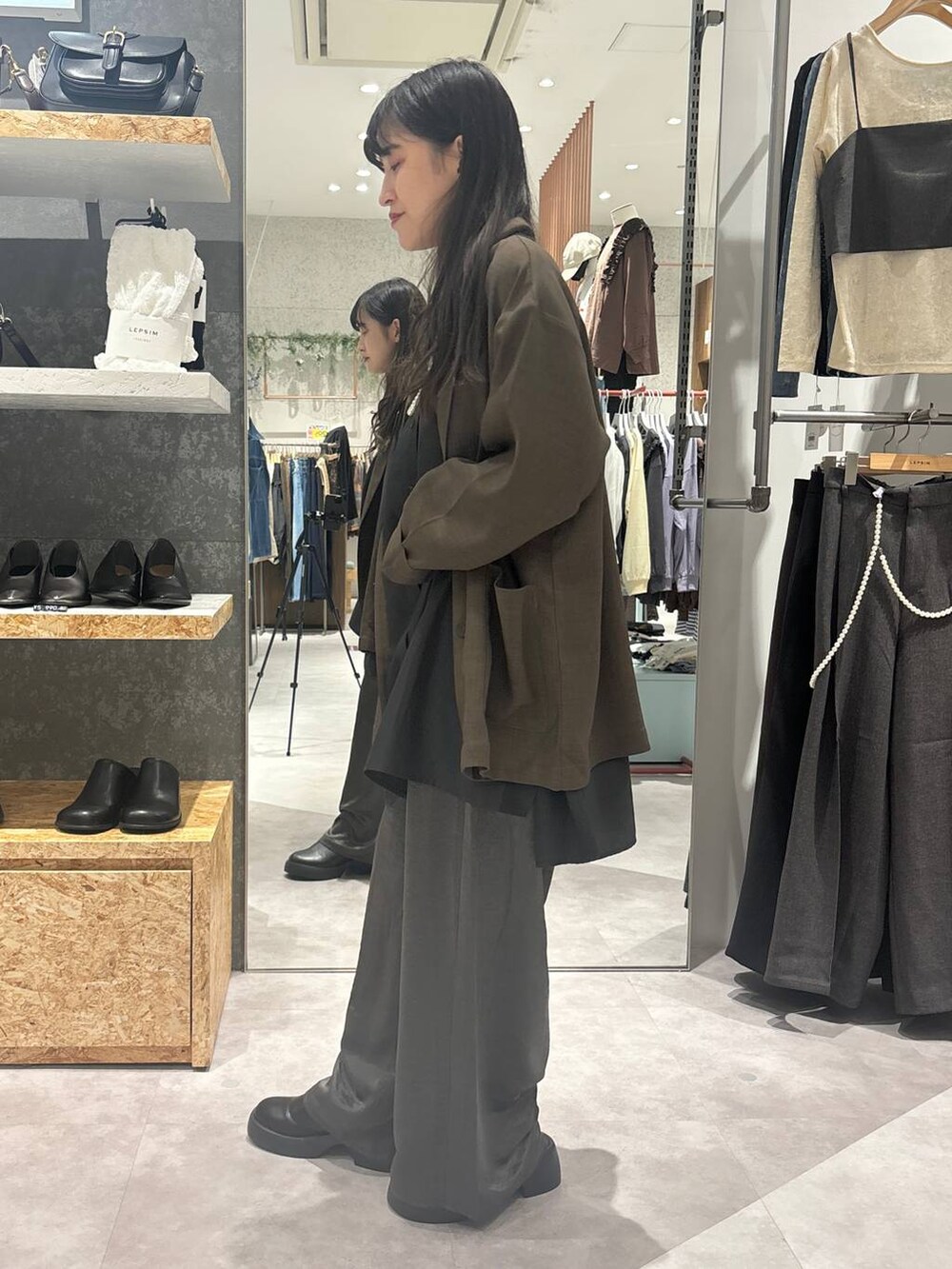 ブラック系のサンダル、グレー系のシャツ/ブラウス、ブラウン系のテーラードジャケットを着用したレディースの冬コーディネートの3枚目の写真