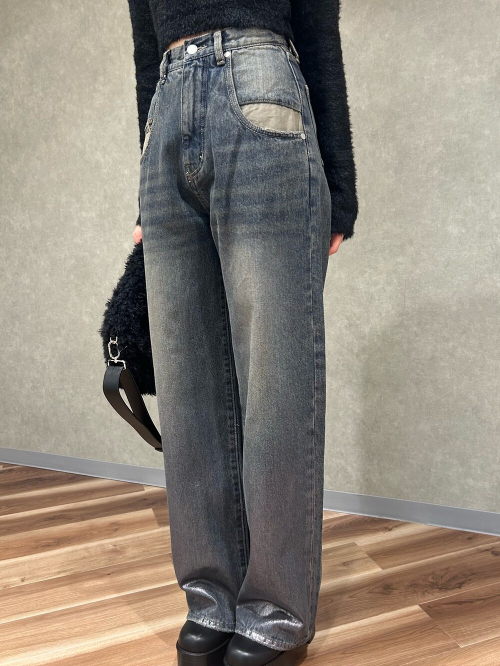 ブラック系のニット/セーター、ブラック系のブーツ、ブラック系のハンドバッグを着用したレディースの冬コーディネートの6枚目の写真