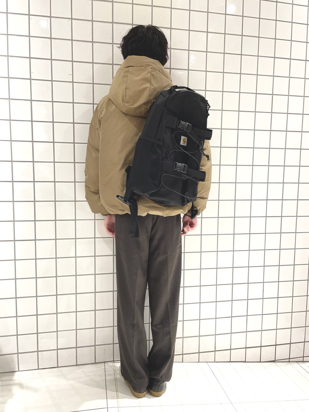 グレー系のその他パンツ、ブラック系のスニーカー、ブラック系のバックパック/リュックを着用したメンズの冬コーディネートの3枚目の写真