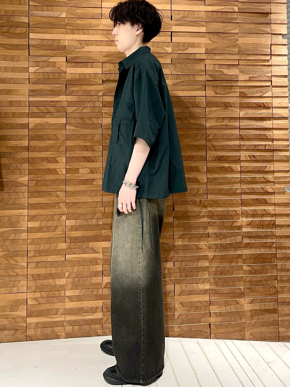 ブラック系のデニムパンツ、グリーン系のシャツ/ブラウス、ブラック系のTシャツ/カットソーを着用したメンズの夏コーディネートの2枚目の写真