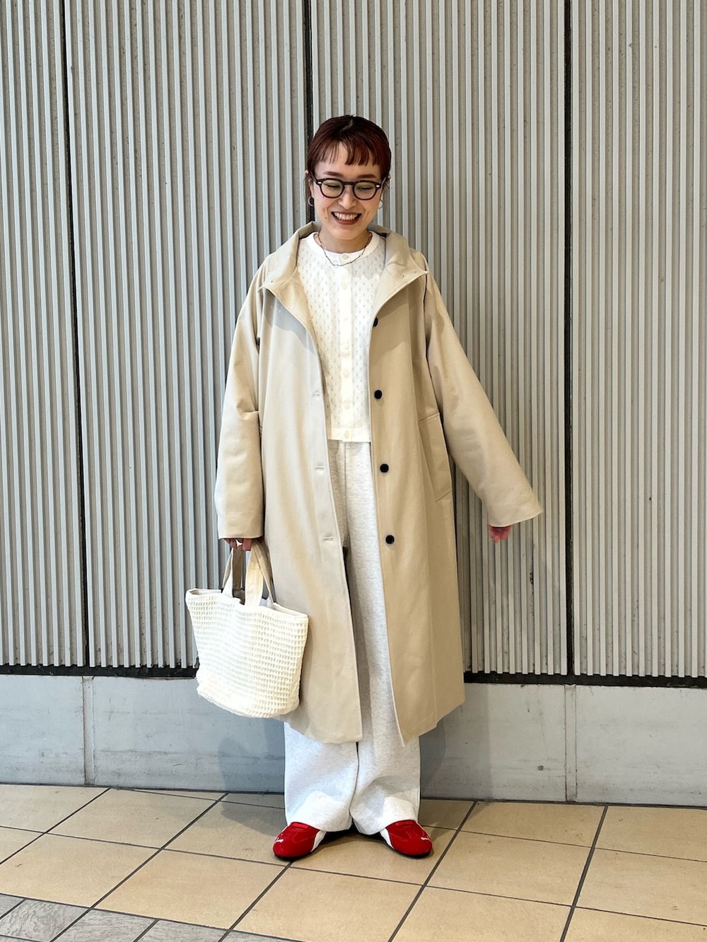 ホワイト系のカーディガン/ボレロ、レッド系のスニーカー、ホワイト系のトートバッグを着用したレディースの春コーディネートの3枚目の写真