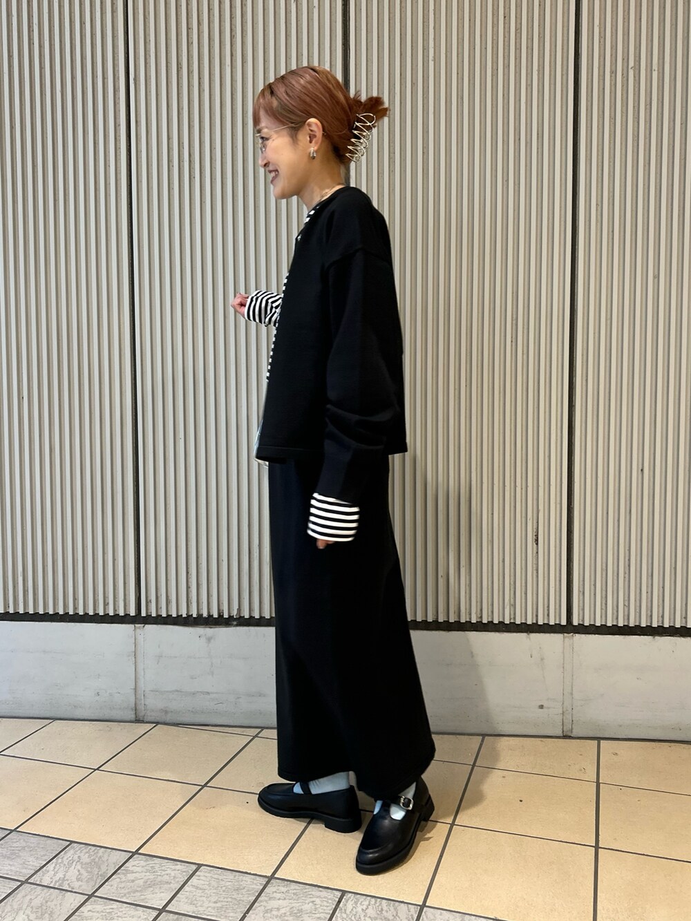 ブラック系のカーディガン/ボレロ、ブラック系のスカート、ホワイト系のTシャツ/カットソーを着用したレディースの秋コーディネートの2枚目の写真