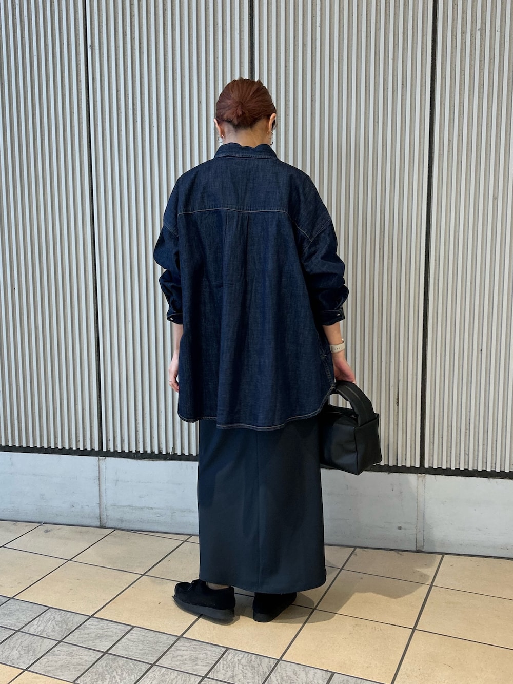 レッド系のカーディガン/ボレロ、ホワイト系のTシャツ/カットソー、ブルー系のスカートを着用したレディースの冬コーディネートの2枚目の写真