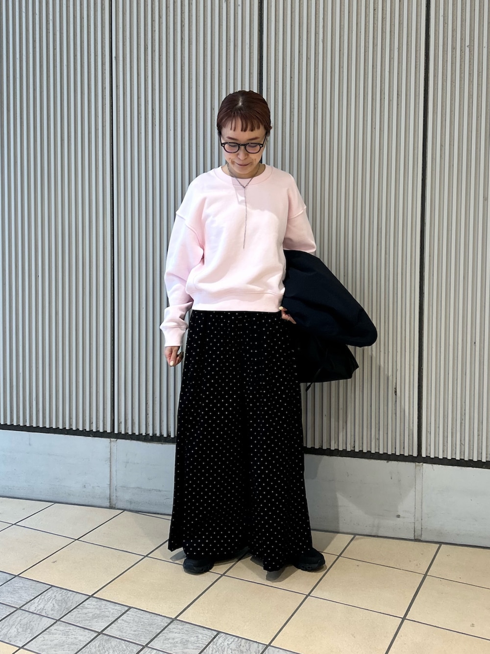 ピンク系のスウェット、ブラック系のその他パンツ、ブラック系のスニーカーを着用したレディースの春コーディネートの3枚目の写真