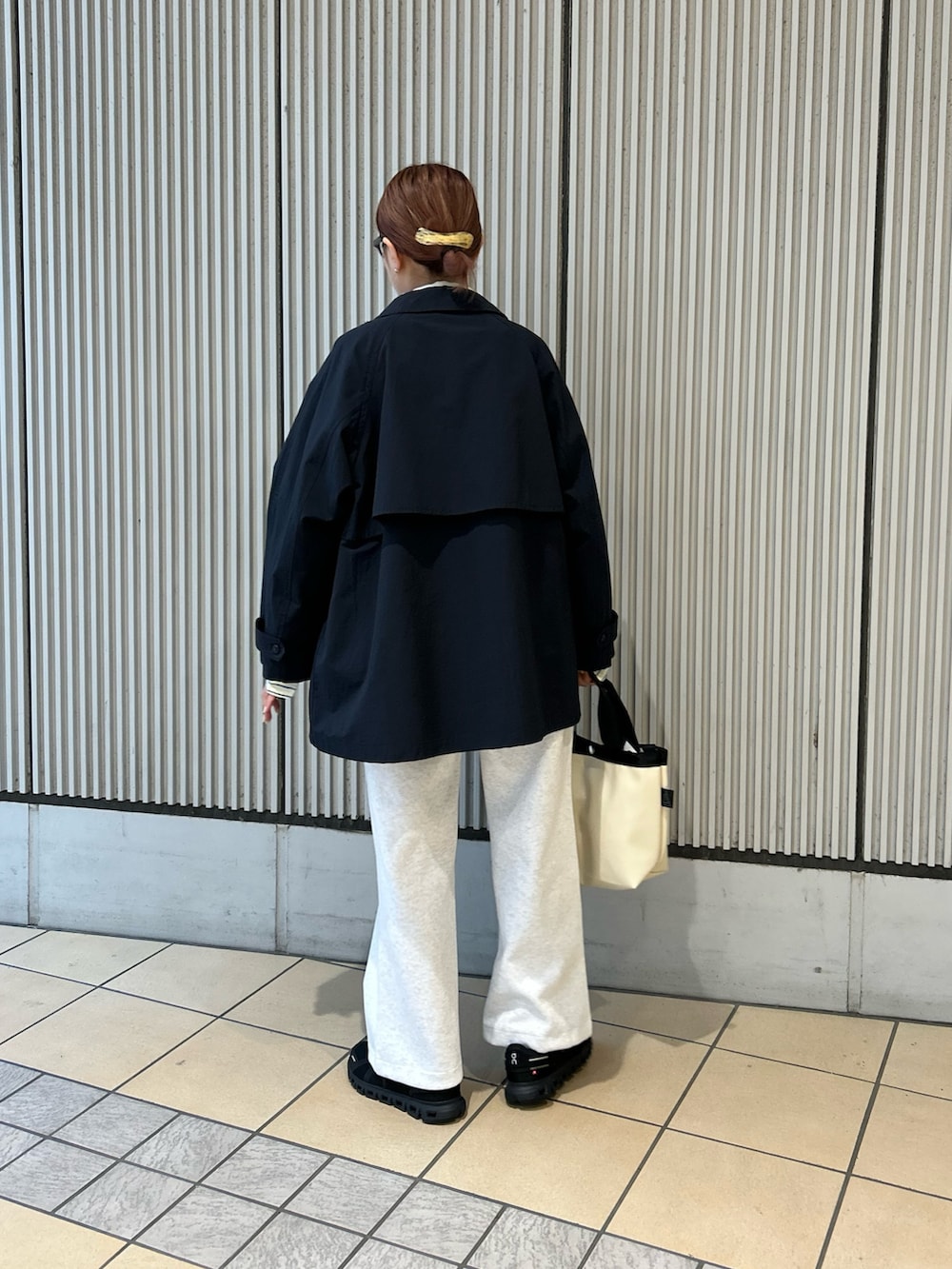 イエロー系のシャツ/ブラウス、ブルー系のステンカラーコート、グレー系のその他パンツを着用したレディースの春コーディネートの3枚目の写真