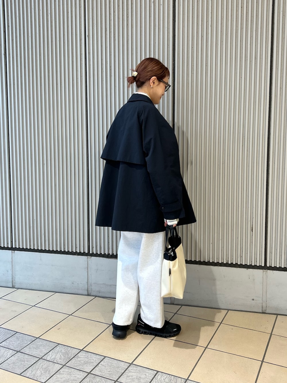 イエロー系のシャツ/ブラウス、ブルー系のステンカラーコート、グレー系のその他パンツを着用したレディースの春コーディネートの2枚目の写真