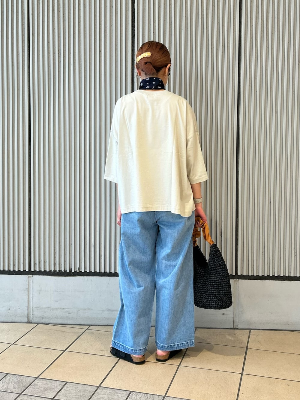 ブルー系のデニムパンツ、グレー系のTシャツ/カットソー、ブラック系のサンダルを着用したレディースの夏コーディネートの3枚目の写真