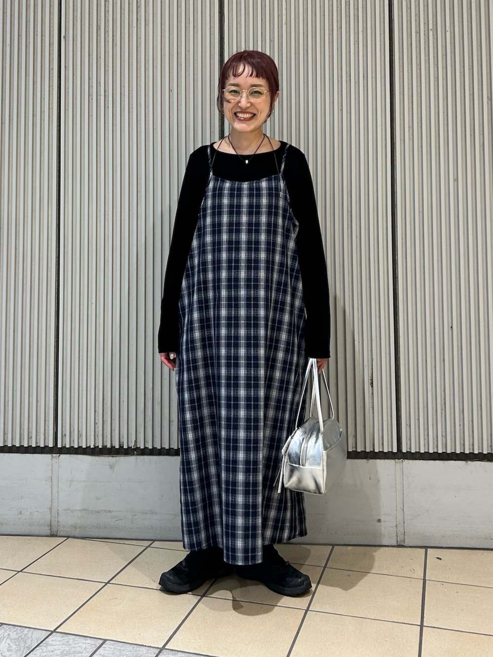 ブルー系のワンピース、ブラック系のTシャツ/カットソー、シルバー系のボストンバッグを着用したレディースの秋コーディネートの4枚目の写真