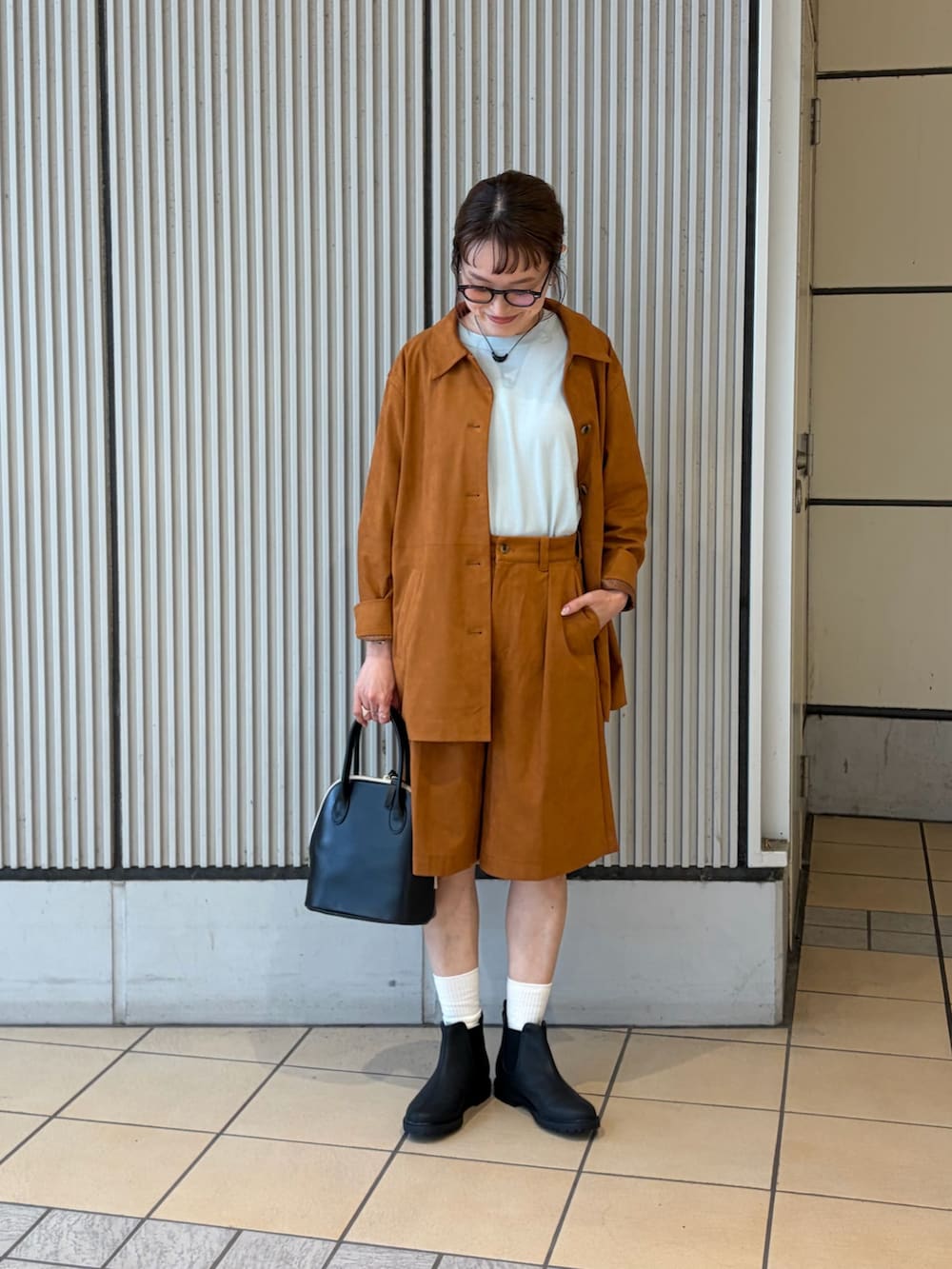 ブルー系のTシャツ/カットソー、ブラウン系のテーラードジャケット、ブラウン系のその他パンツを着用したレディースの秋コーディネートの4枚目の写真