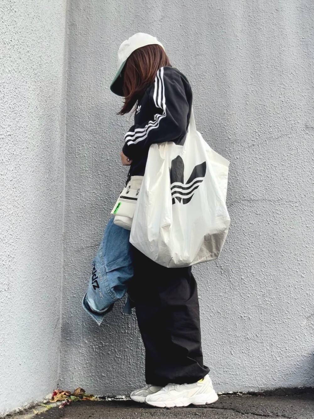 ブラック系のスウェット、ブルー系のシャツ/ブラウス、ブラック系のパンツを着用したレディースの秋コーディネートの3枚目の写真