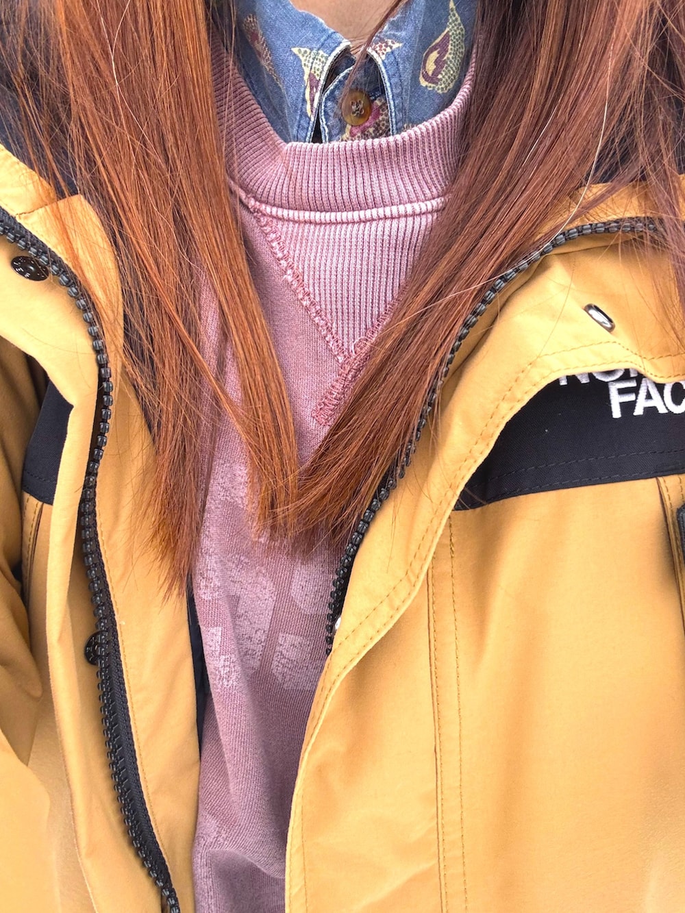 ベージュ系のダウンジャケット/コート、グリーン系のスニーカー、ブルー系のシャツ/ブラウスを着用したレディースの冬コーディネートの3枚目の写真