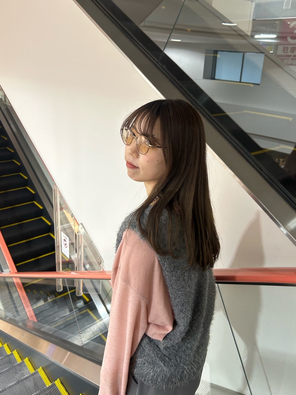 グレー系のベスト、ピンク系のTシャツ/カットソー、グレー系のスウェットパンツを着用したレディースの春コーディネートの3枚目の写真