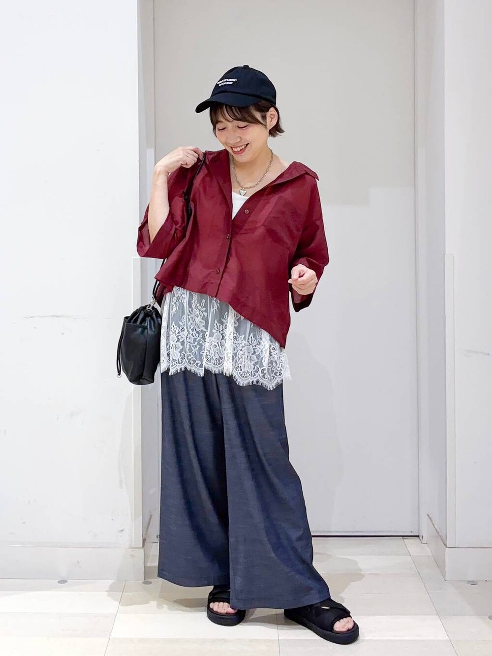 ホワイト系のキャミソール、ブルー系のその他パンツ、ブラック系のサンダルを着用したレディースの夏コーディネートの2枚目の写真