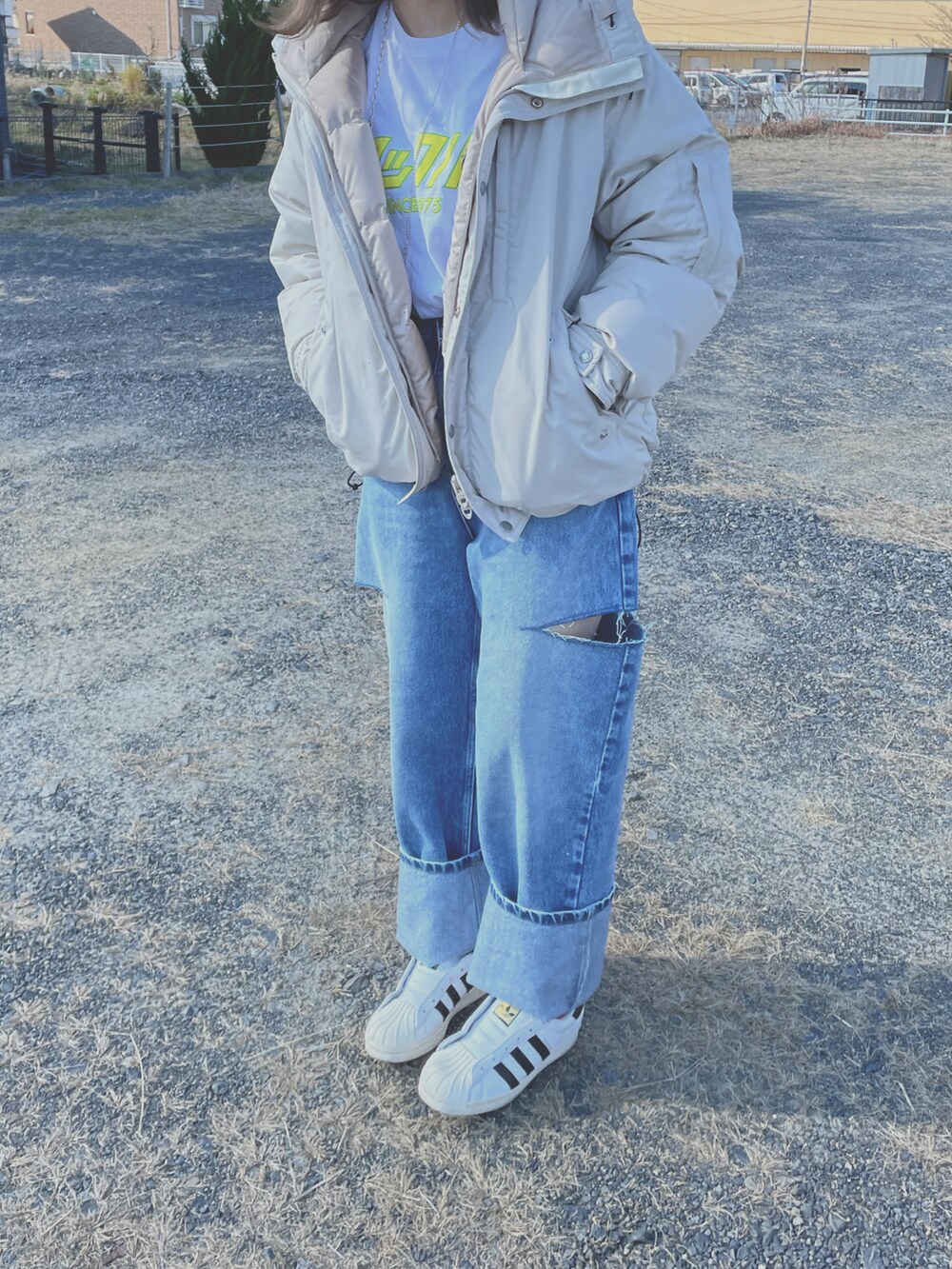 ブルー系のデニムパンツ、ホワイト系のTシャツ/カットソー、ホワイト系のスニーカーを着用したレディースの冬コーディネートの2枚目の写真