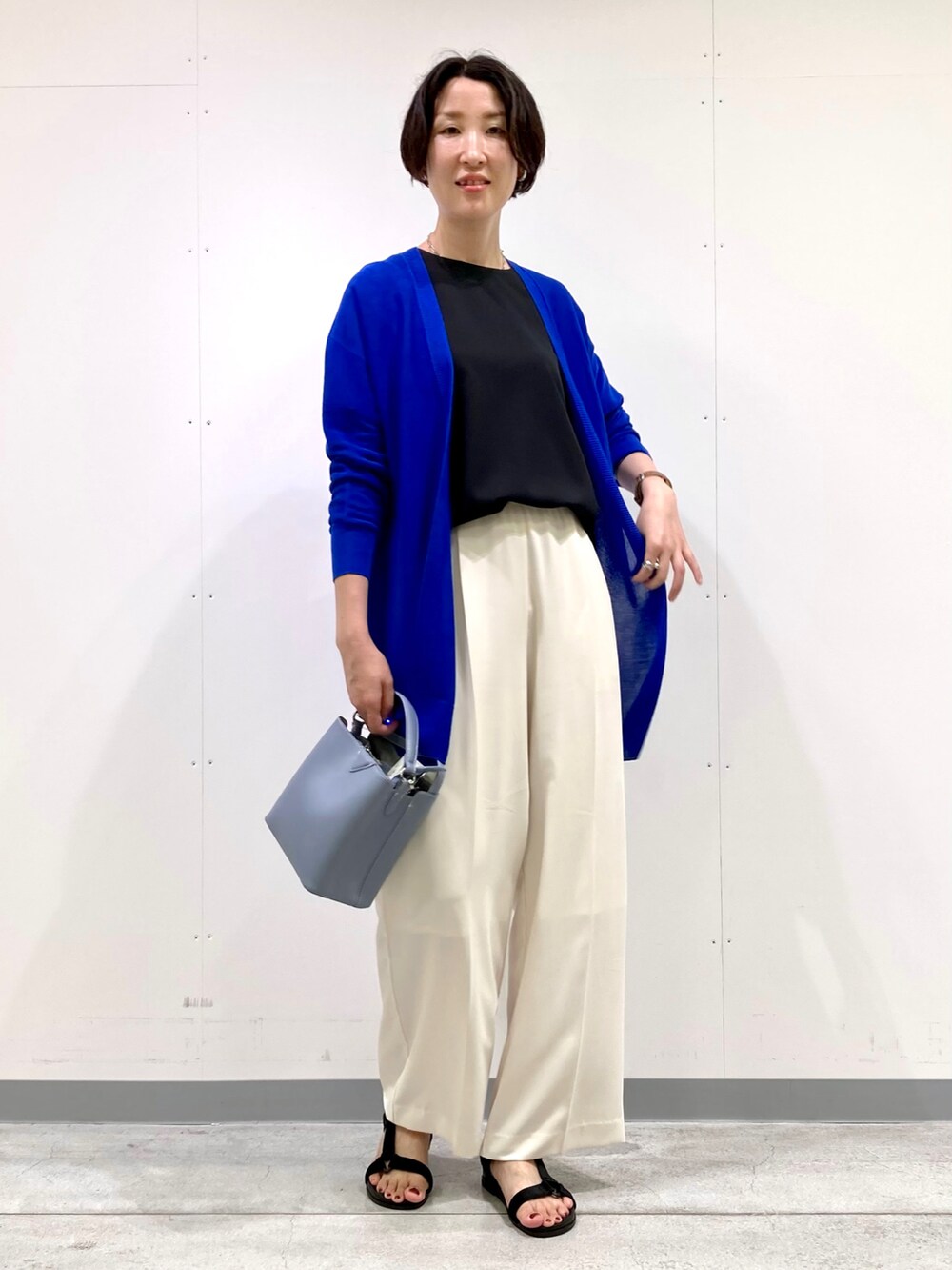 ブラック系のシャツ/ブラウス、ブルー系のカーディガン/ボレロ、ホワイト系のその他パンツを着用したレディースの秋コーディネートの4枚目の写真