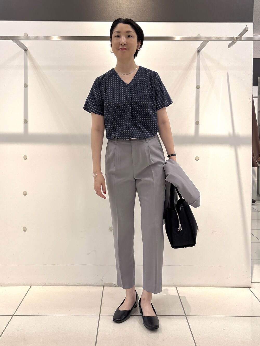 グレー系のスーツジャケット、グレー系のシャツ/ブラウス、グレー系のスーツパンツを着用したレディースの夏コーディネートの10枚目の写真