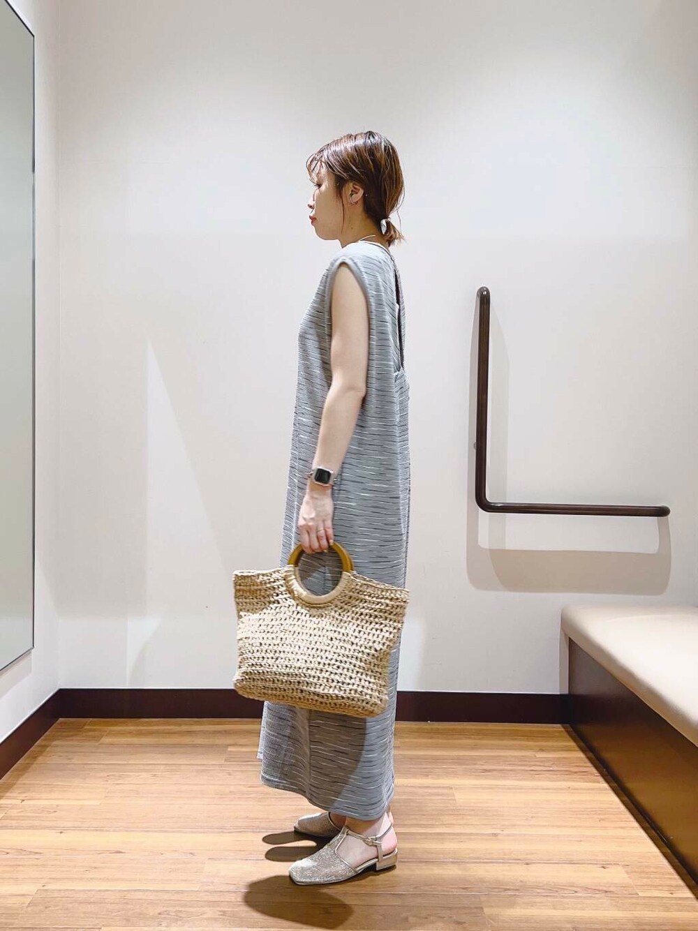 ベージュ系のトートバッグ、グレー系のワンピースを着用したレディースの夏コーディネートの4枚目の写真