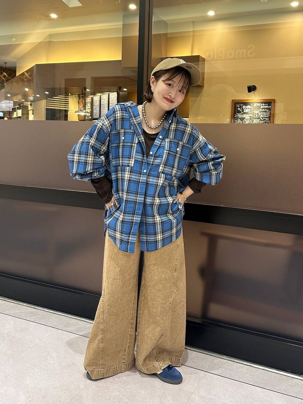 ブラウン系のデニムパンツ、ブルー系のシャツ/ブラウス、ブラウン系のTシャツ/カットソーを着用したレディースの夏コーディネートの2枚目の写真