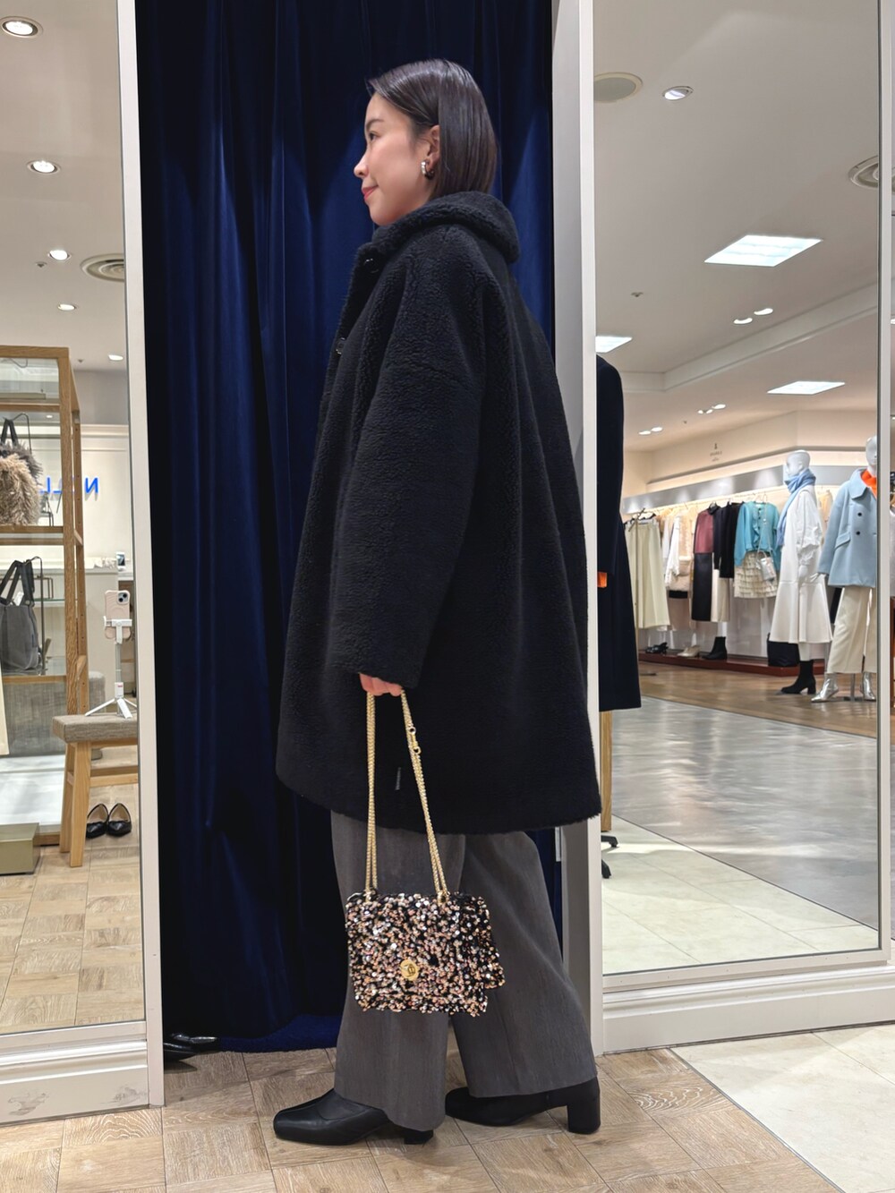 ピンク系のニット/セーター、ブラック系のダッフルコート、その他のショルダーバッグを着用したレディースの冬コーディネートの3枚目の写真