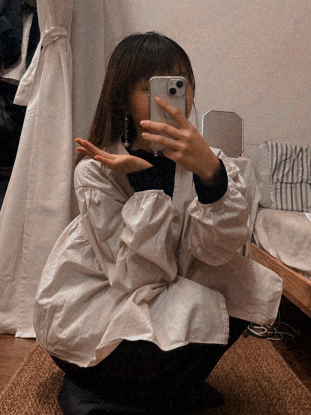 グレー系のパンツ、ホワイト系のトップスを着用したレディースの冬コーディネートの2枚目の写真