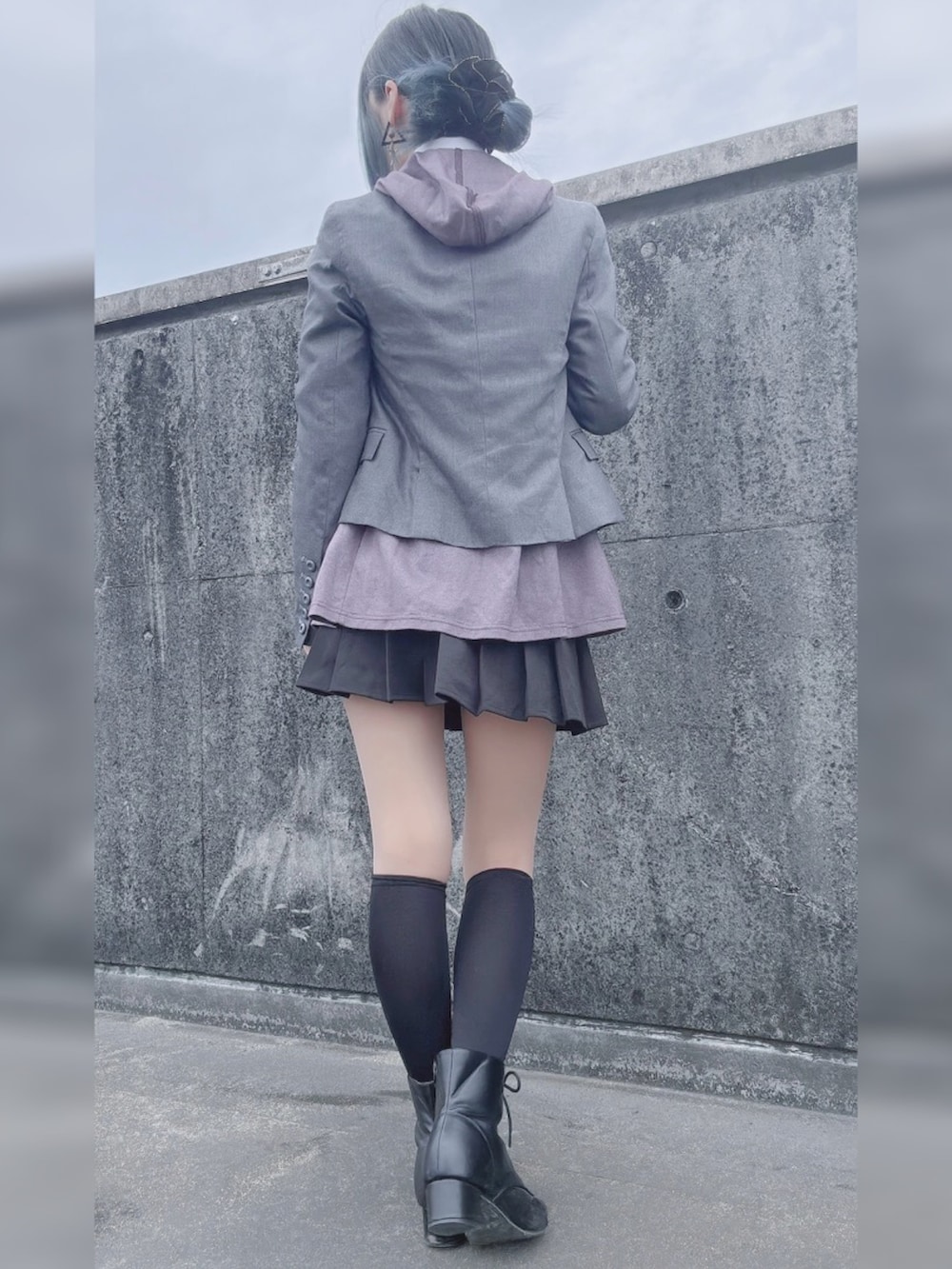 グレー系のテーラードジャケット、パープル系のネクタイ、ブラック系のスカートを着用したレディースの春コーディネートの2枚目の写真