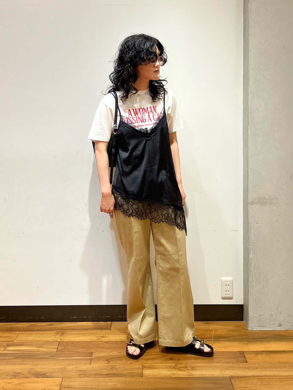 ブラック系のショルダーバッグ、ベージュ系のその他パンツ、ブラック系のキャミソールを着用したレディースの夏コーディネートの3枚目の写真