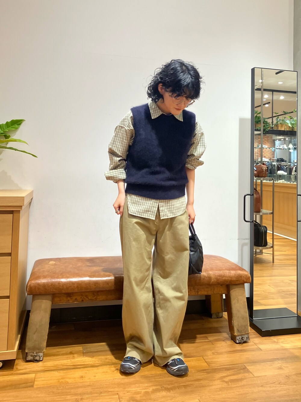 ブラック系のショルダーバッグ、ブラック系のスニーカー、グリーン系のシャツ/ブラウスを着用したレディースの秋コーディネートの4枚目の写真