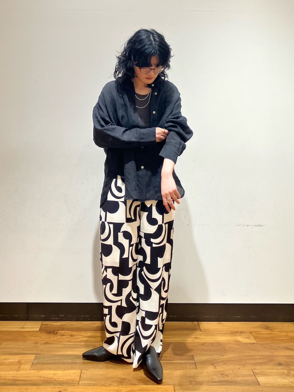 ブラック系のその他パンツ、ブラック系のその他シューズ、グレー系のタンクトップを着用したレディースの春コーディネートの3枚目の写真