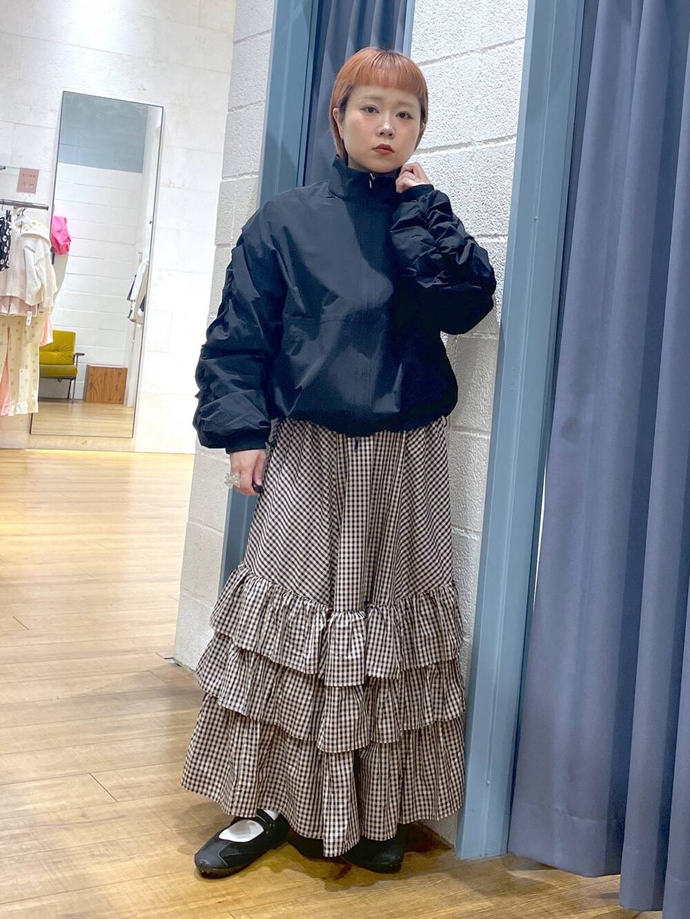 ブラック系のスニーカー、ブラック系のブルゾン、ブラウン系のスカートを着用したレディースの春コーディネートの4枚目の写真