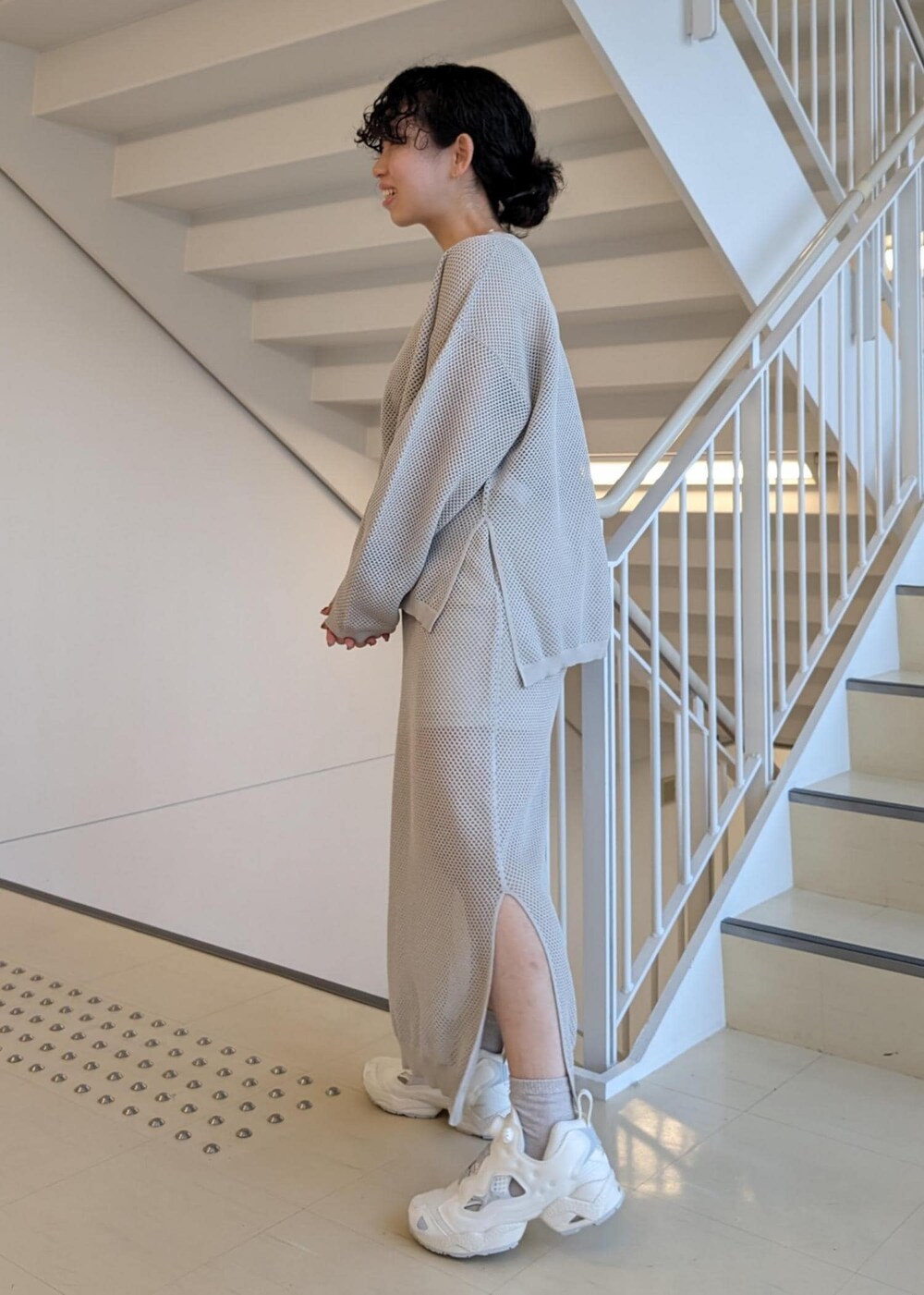 ブラック系のキャミソール、ベージュ系のスニーカー、シルバー系のTシャツ/カットソーを着用したレディースの春コーディネートの4枚目の写真