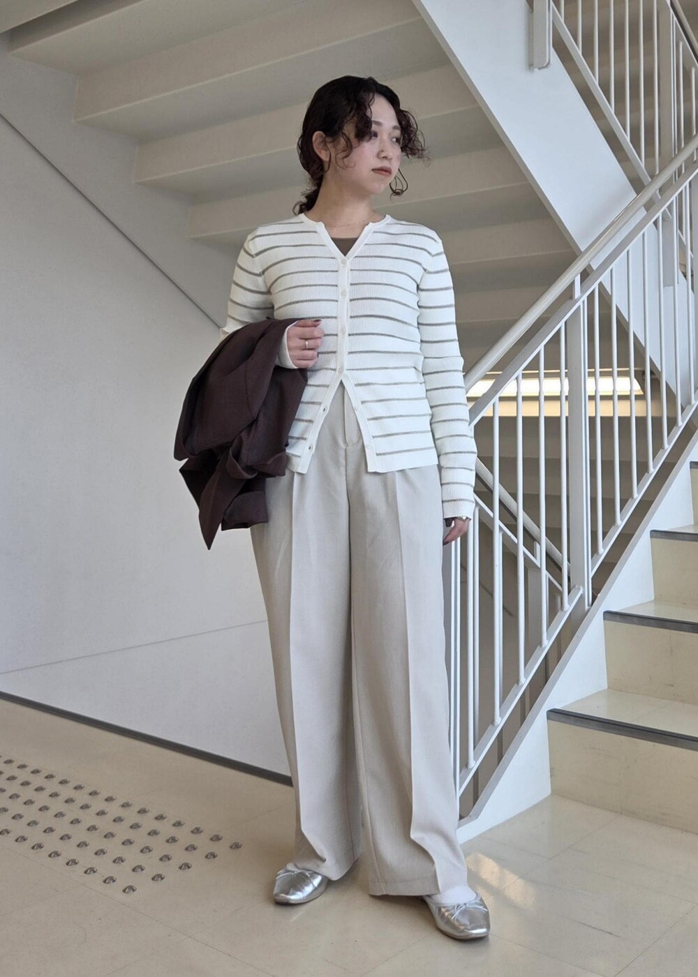 ホワイト系のカーディガン/ボレロ、ベージュ系のその他パンツ、シルバー系のバレエシューズを着用したレディースの春コーディネートの6枚目の写真