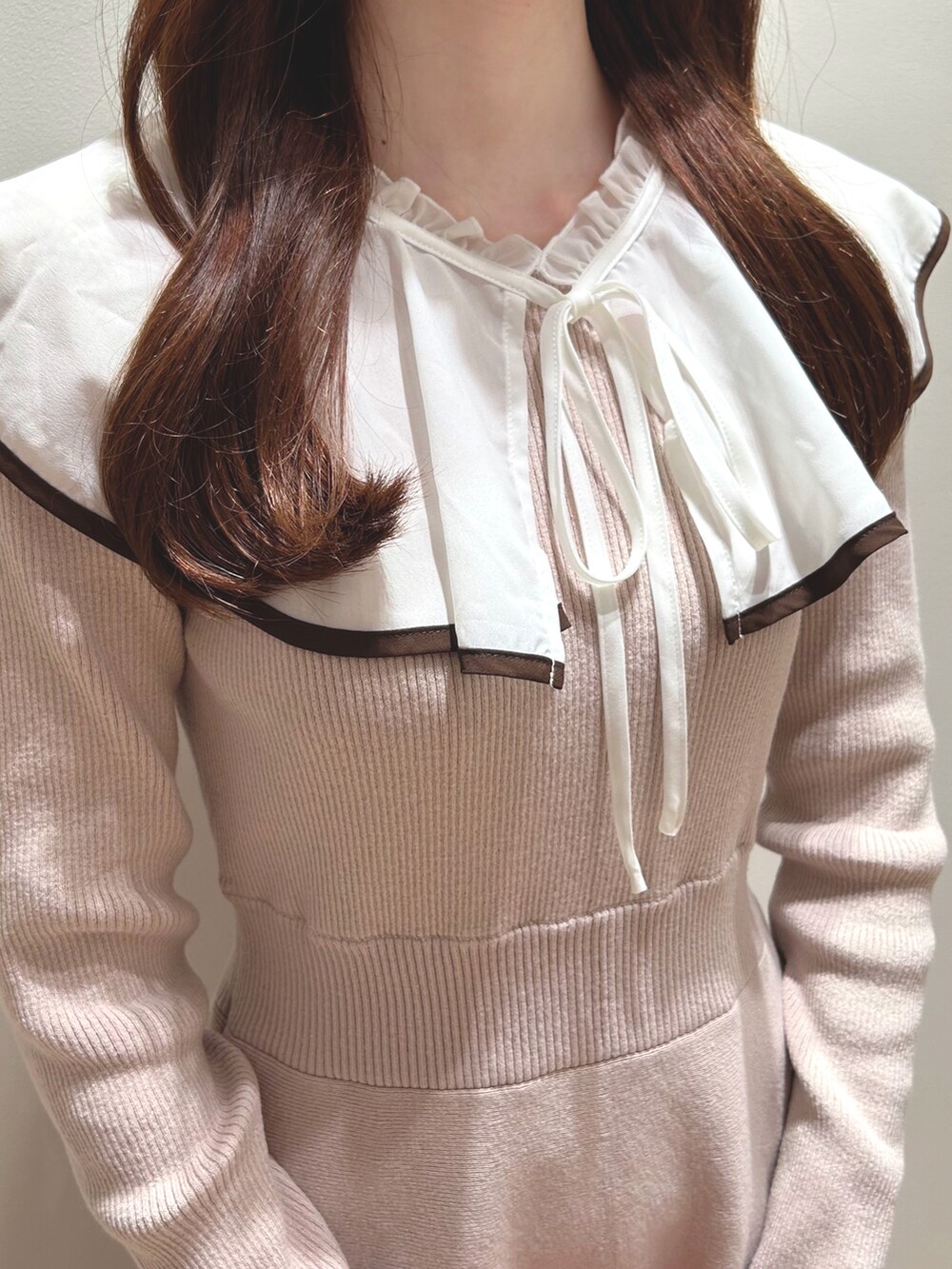 ピンク系のワンピースを着用したレディースの秋コーディネートの3枚目の写真