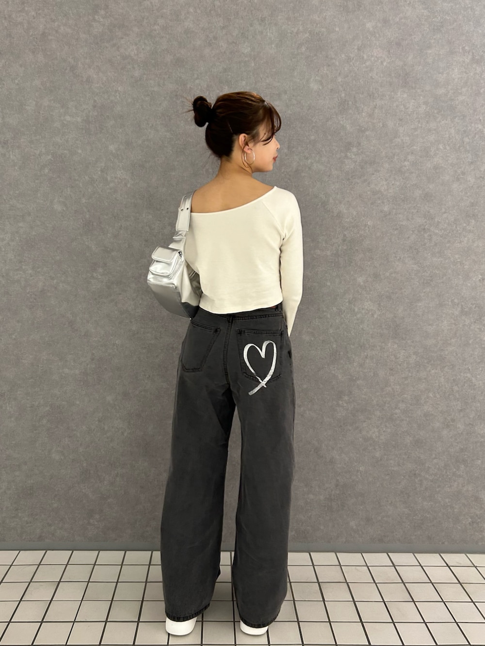 ホワイト系のTシャツ/カットソー、グレー系のデニムパンツ、ホワイト系のスニーカーを着用したレディースの冬コーディネートの2枚目の写真