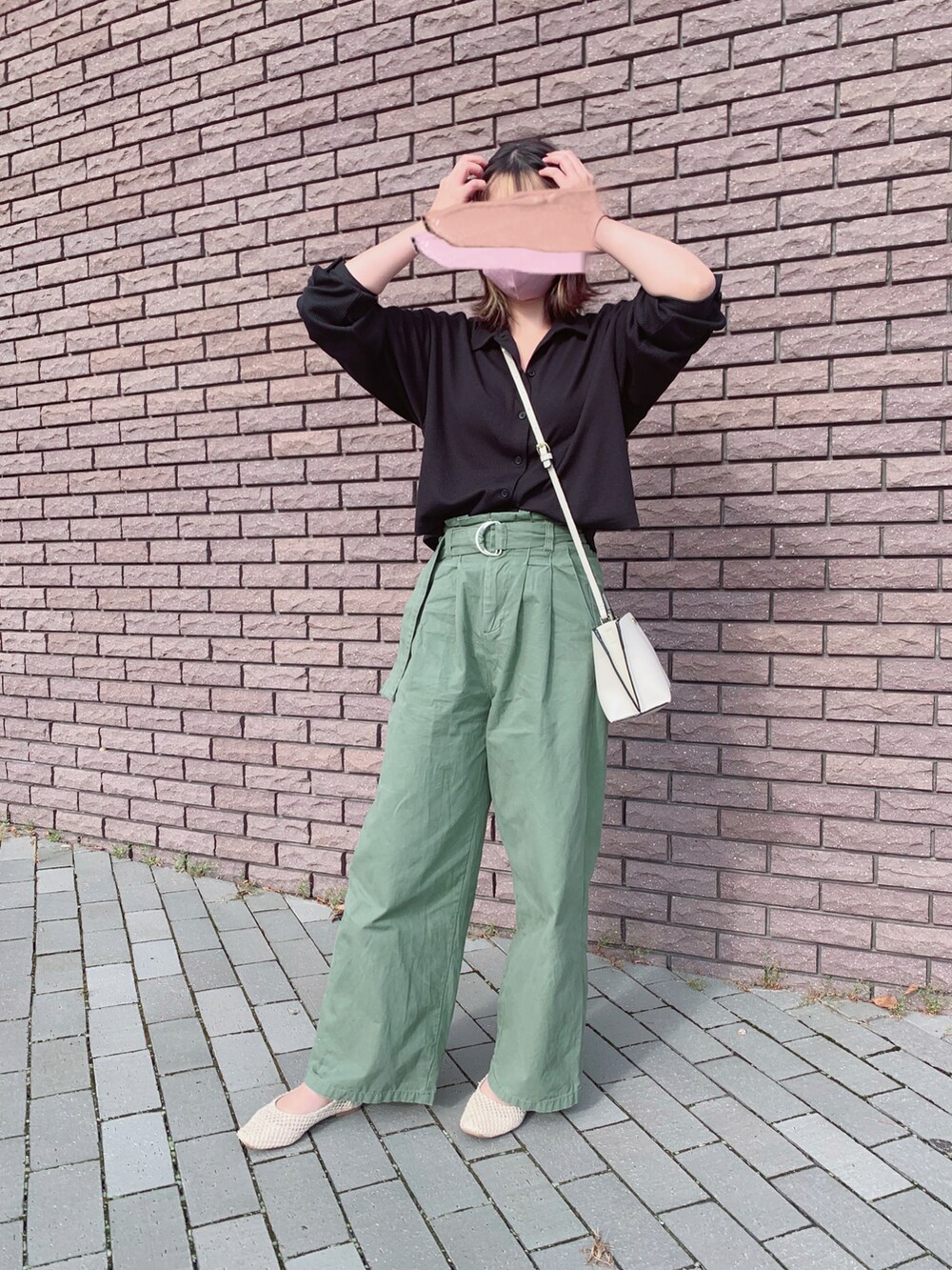 ベージュ系のバレエシューズ、グリーン系のパンツ、ベージュ系のショルダーバッグを着用したレディースの秋コーディネートの2枚目の写真