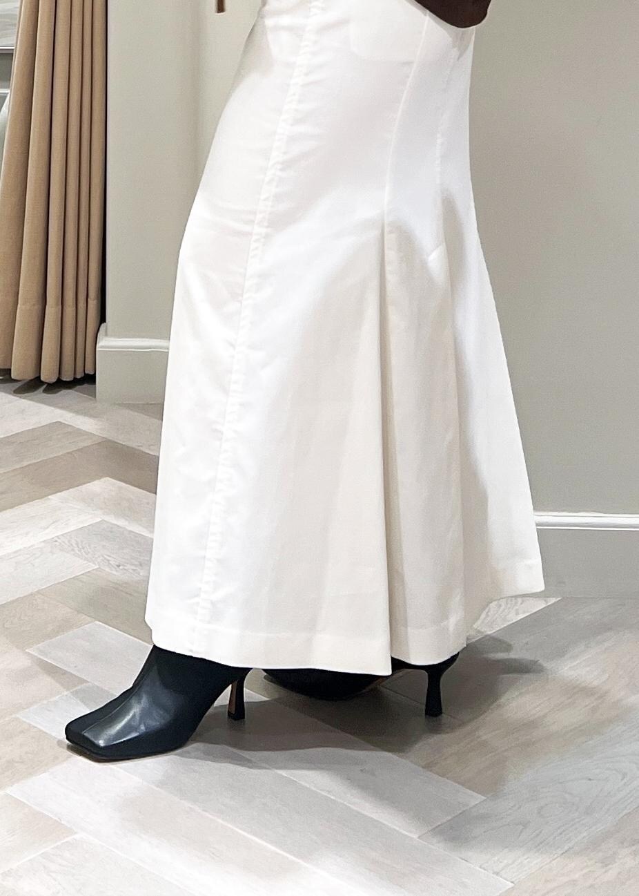 ブラック系のブーツ、ホワイト系のスカート、ブラウン系のTシャツ/カットソーを着用したレディースの秋コーディネートの8枚目の写真