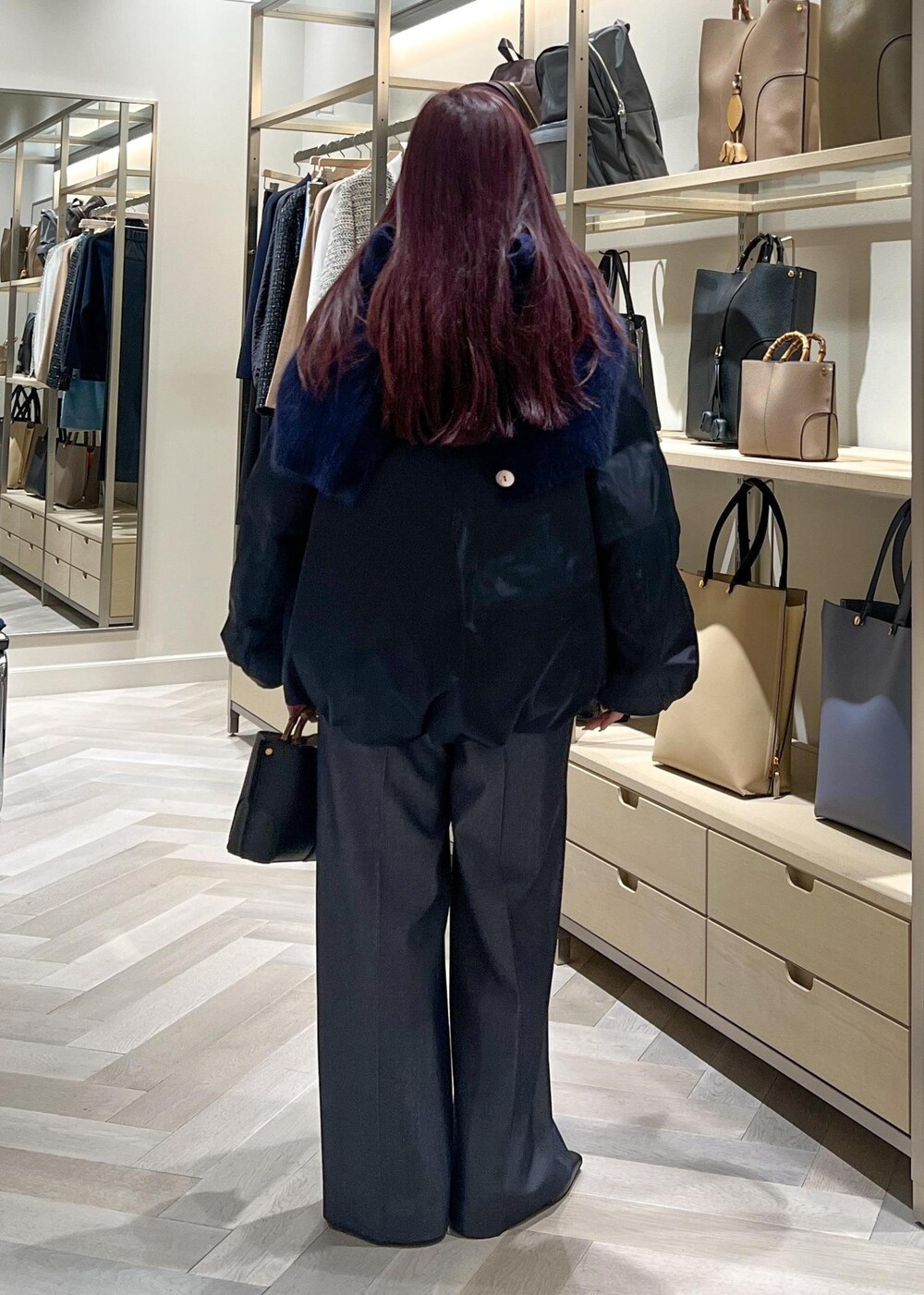 ブラック系のブーツ、グレー系のニット/セーター、ブルー系のその他パンツを着用したレディースの秋コーディネートの4枚目の写真