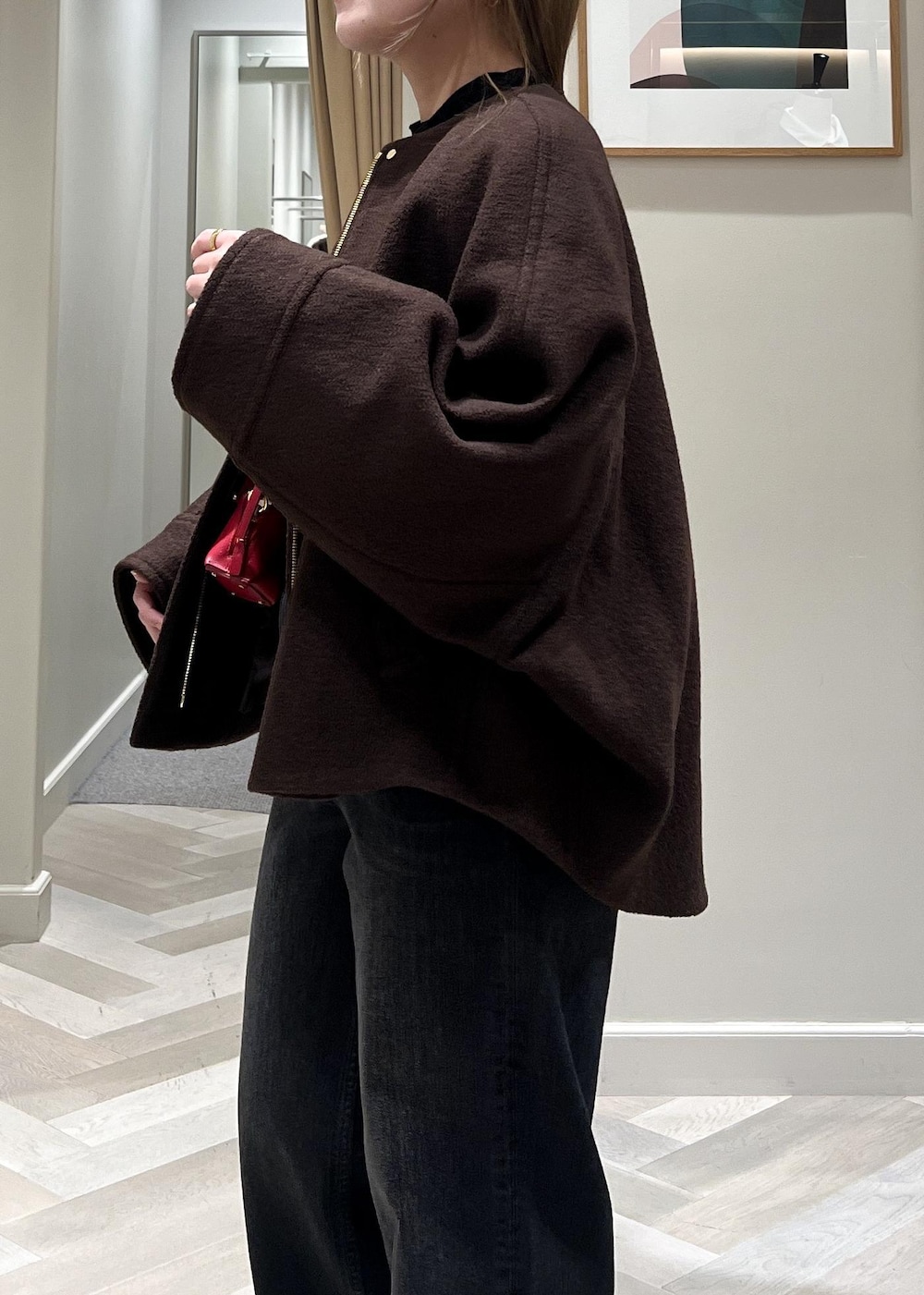 ブラック系のデニムパンツ、ブラック系のブーツ、ブラウン系のブルゾンを着用したレディースの秋コーディネートの7枚目の写真