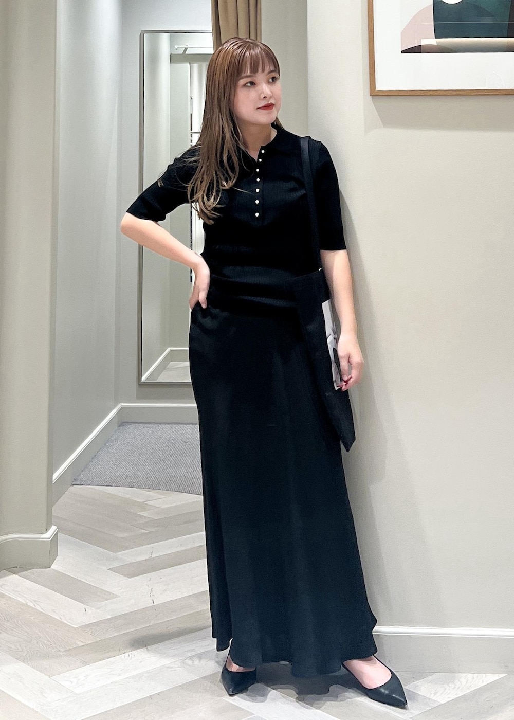 ブラック系のパンプス、ブラック系のスカート、ブラック系のニット/セーターを着用したレディースの秋コーディネートの5枚目の写真