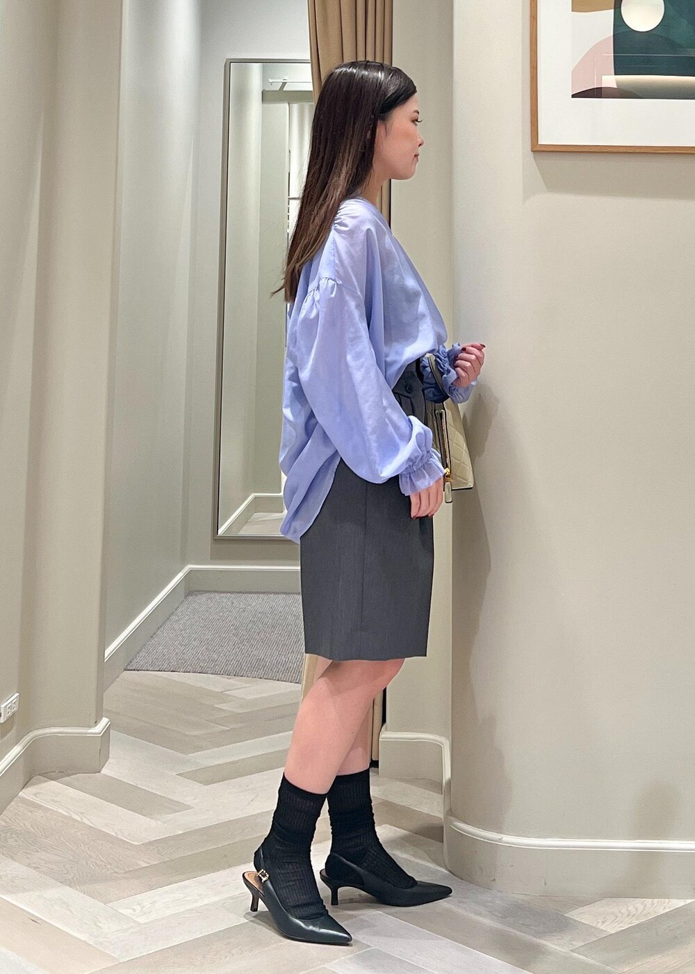 ブラック系のパンプス、グレー系のその他パンツ、ベージュ系のハンドバッグを着用したレディースの秋コーディネートの3枚目の写真