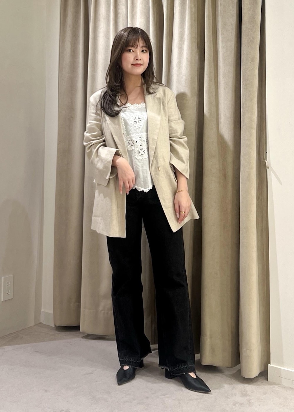 グレー系のデニムパンツ、ブラック系のパンプス、ホワイト系のキャミソールを着用したレディースの春コーディネートの7枚目の写真