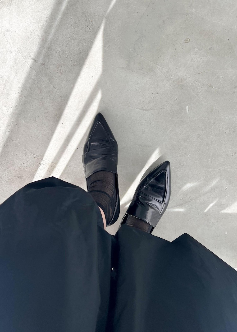 グレー系のニット/セーター、ブルー系のマウンテンパーカー、ブラック系のパンプスを着用したレディースの冬コーディネートの6枚目の写真