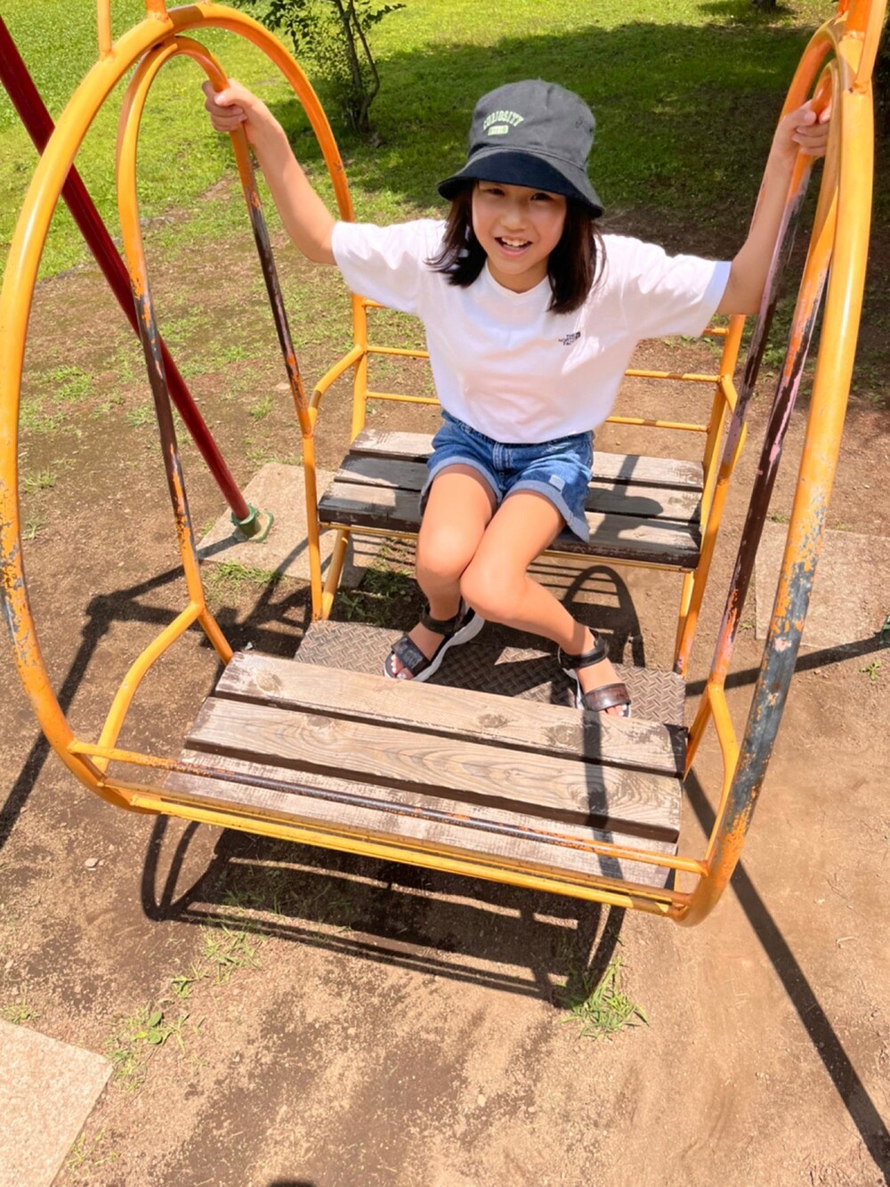 ホワイト系のTシャツ/カットソー、ブルー系のデニムパンツ、ブラック系のハットを着用したキッズの夏コーディネートの2枚目の写真